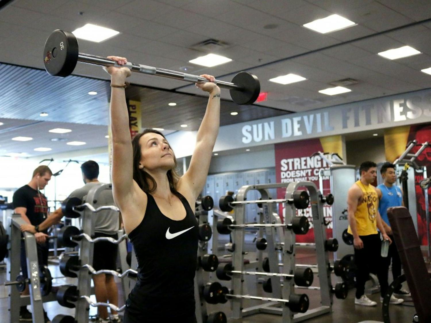 Christa Caccese, the Vice President of Ladies who Lift club and an ASU senior majoring in nutrition communication, lifts weights at the Sun Devil Fitness Complex on the downtown Phoenix campus on Nov. 23, 2016. 