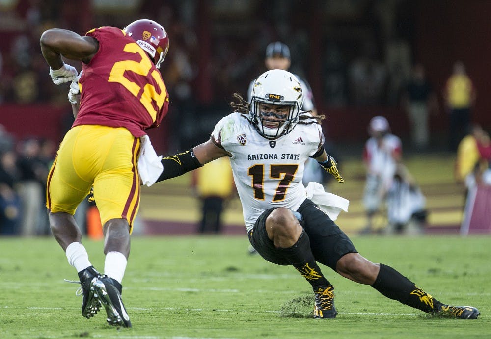 ASU Sun Devils defensive back J'Marcus Rhodes (17) jukes over in an attempt to take down Trojan wide receiver Josh Imatorbhebhe (22) during a game against the USC Trojans in the Los Angeles Memorial Coliseum on Saturday, Oct. 1, 2016. 