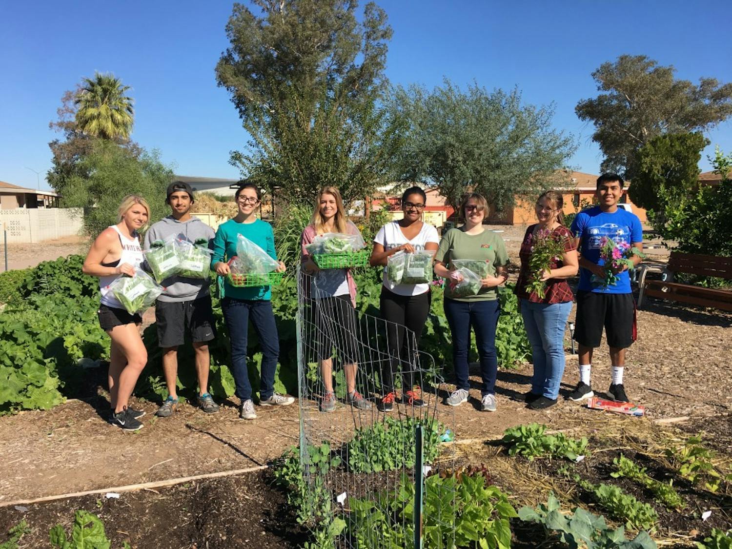 ASU students pose for a group photo&nbsp;while learning new gardening initiatives in the garden at ASU's Polytechnic campus. The garden was highlighted in the Best of Green Schools award.