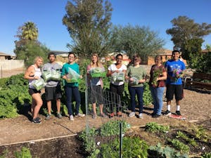 ASU students pose for a group photo&nbsp;while learning new gardening initiatives in the garden at ASU's Polytechnic campus. The garden was highlighted in the Best of Green Schools award.