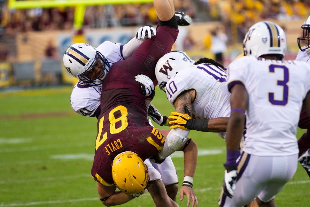 Senior tight end  Chris Coyle is tackled by washington defenders at a game in Tempe. The Sun Devils play Washington State for their next game on the road. (Photo by Vince Dwyer)