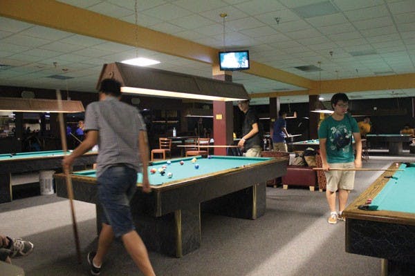 Students play pool at MU After Dark on Sept. 21. The event is held in the Memorial Union every Friday night on the Tempe campus. Sparky's Den offers free bowling at 10:30 p.m., and half-price around 8 p.m. Students come for the arcade, billiards and bowling. (Photo by Marissa Krings)