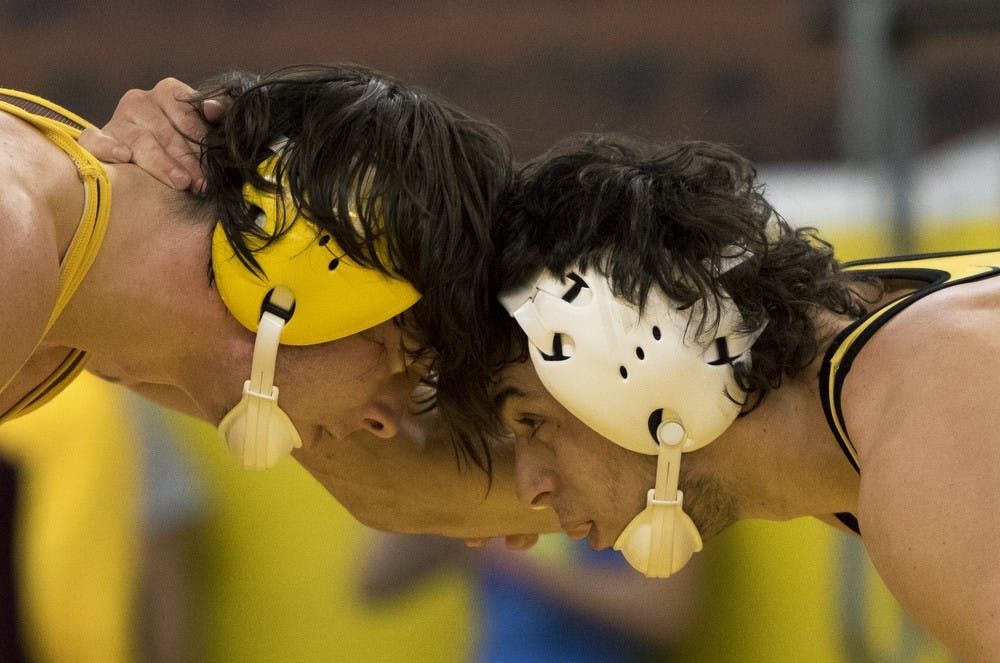 Sophomore Robbie Mathers, right, competes against redshirt freshman Koby Reyes during an intrasquad match on Friday, Oct. 30, 2015, at Ritches Wrestling Complex in Tempe. Mathers defeated Reyes 7-1. 