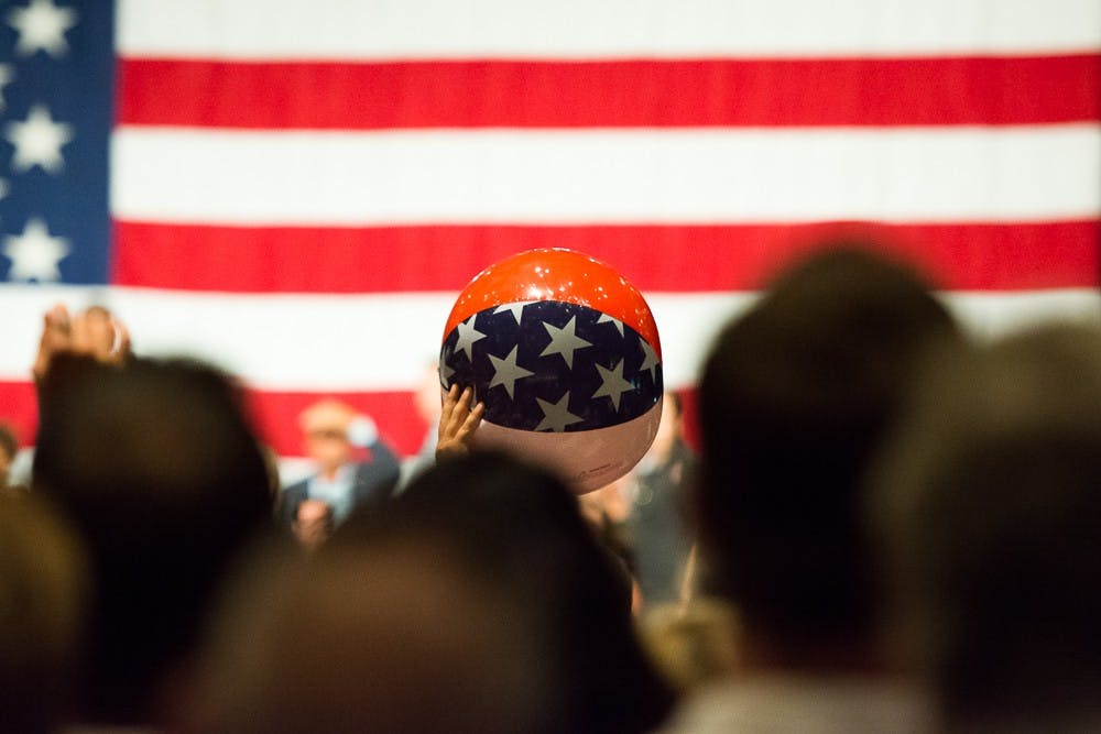 An American flag-themed beach ball is intercepted by a security guard on Saturday, July 11, 2015, at the Phoenix Convention Center. The crowd was waiting for presidential candidate Donald Trump to take the stage for a speech on illegal immigration.