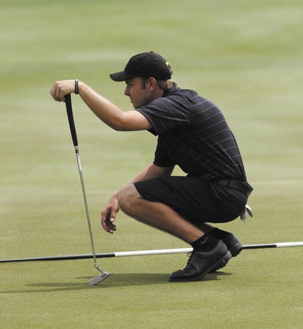 Sophomore Austin Quick reads the green prior to attempting a putt during the ASU Thunderbird Invitational last April. (Photo by Sam Rosenbaum)