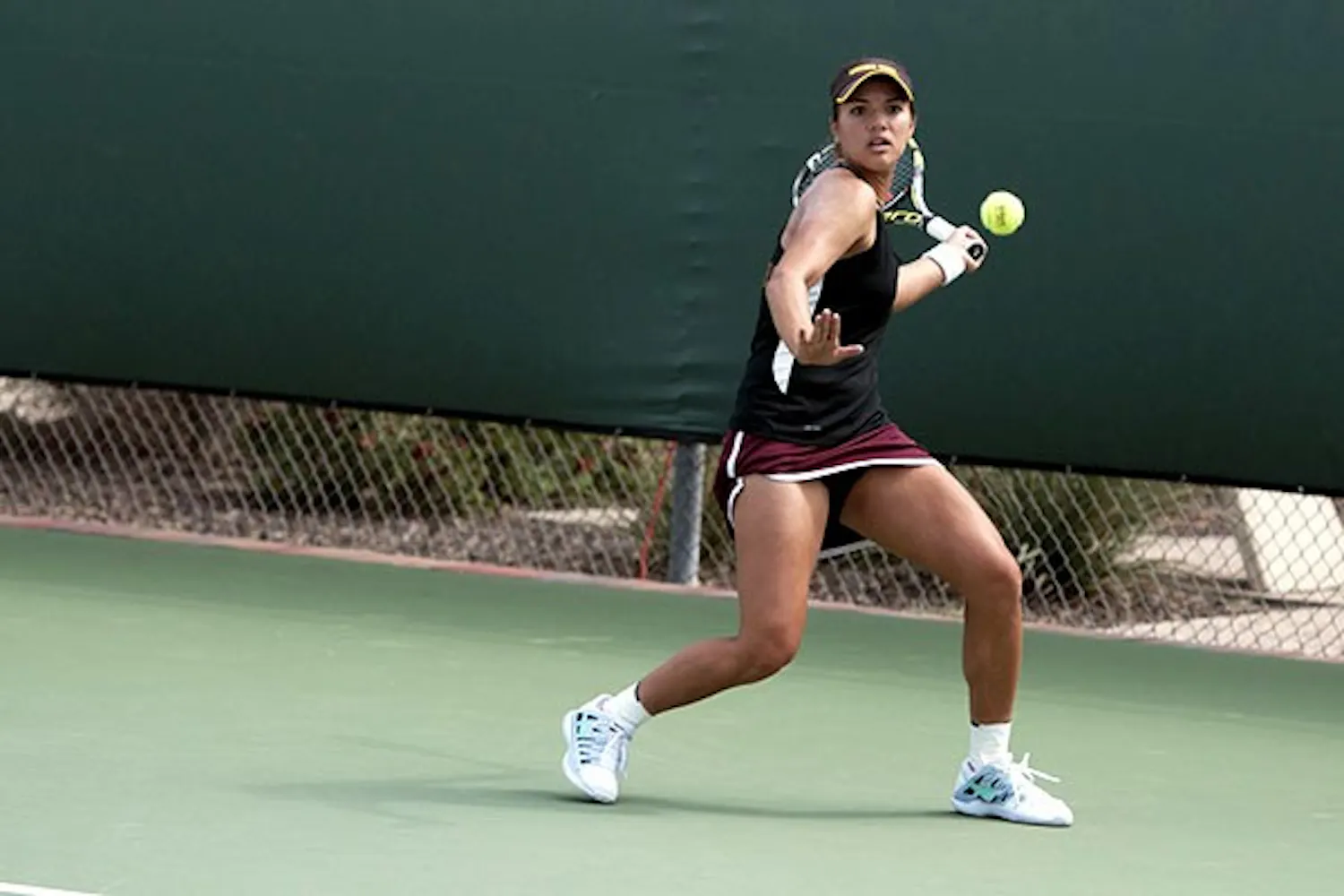 Sophomore Desirae Krawczyk returns the ball with a forehand in a doubles match against Colorado on April 4. (Photo by Mario Mendez)