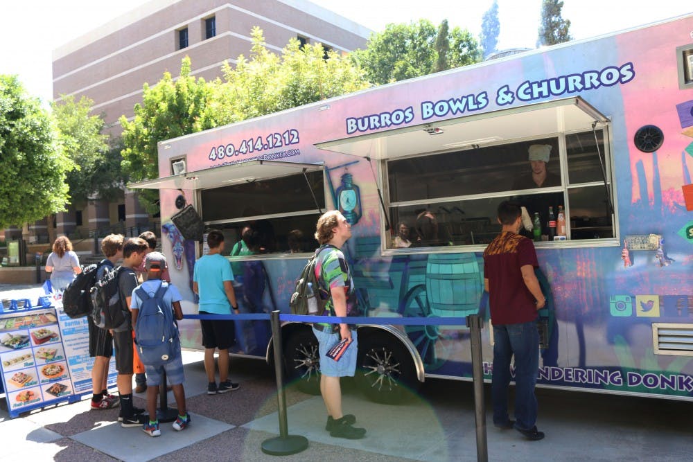 ASU students wait in line to buy food at the Wandering Donkey food truck on the West campus on Sept. 6, 2016.