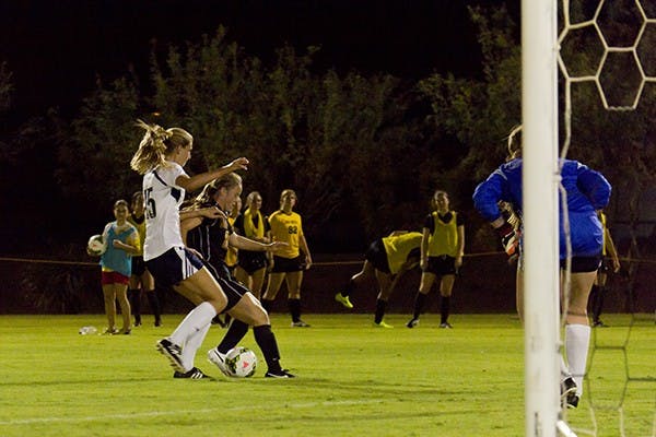 Sophomore forward Aly Moon dribbles the ball around her opponent in a home scrimmage against NAU on Aug. 15. 