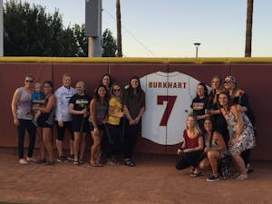 Katie Burkhart poses by the Wall of Honor after her jersey was retired by the ASU softball team on Saturday, April 23, 2016 at Farrington Stadium in Tempe, Arizona.&nbsp;As an collegiate&nbsp;athlete, she had a record of 118-40, an ERA of 1.08 and won the College World Series in 2008.