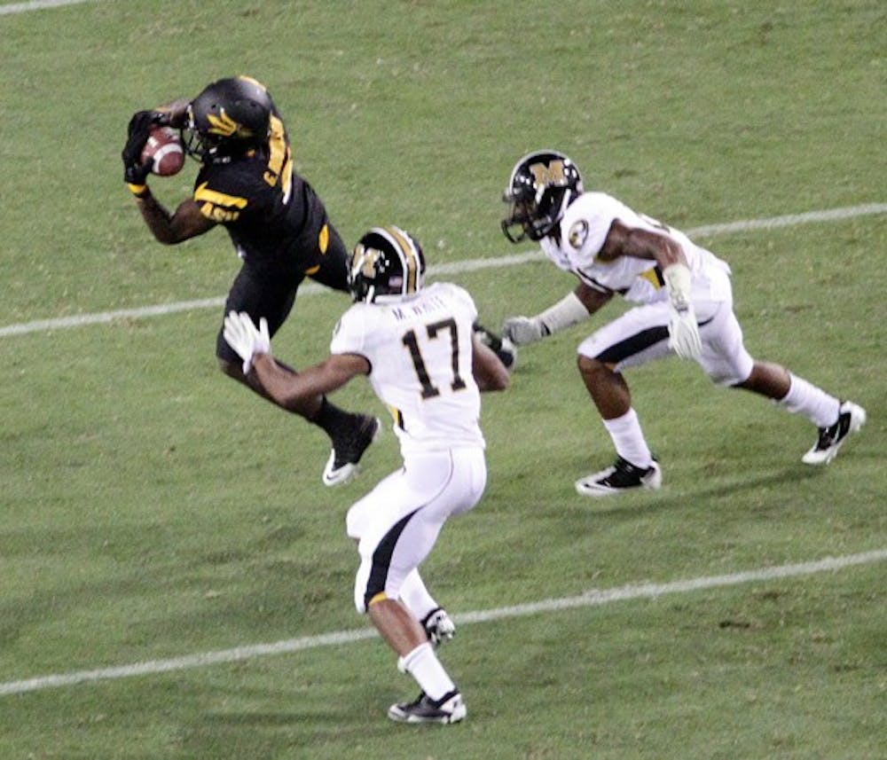 OLD FRIENDS: ASU senior wide receiver Gerell Robinson makes a leaping catch during the Sun Devils’ victory over Missouri on Sept. 9. Robinson, a Chandler Hamilton product, will be reunited with former Hamilton teammate Reuben Robinson when ASU plays Oregon State on Saturday. (Photo by Beth Easterbrook)