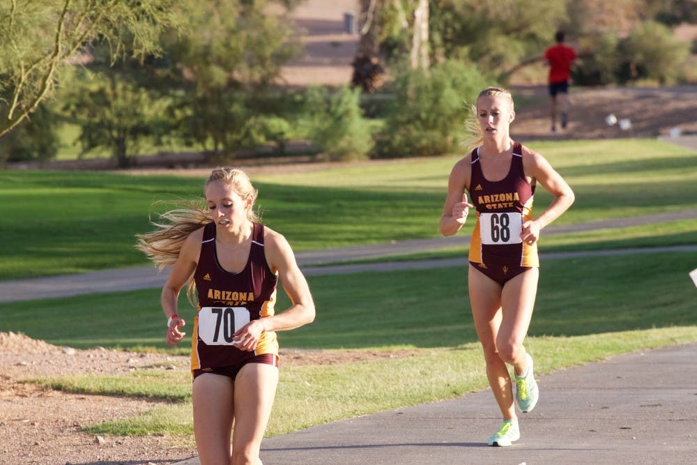 Kaitlin Kaluzny (70) and Shaina Corbin (68) run their first lap during the ASU cross country invitational on Friday, Oct. 23, 2015, at Papago Golf Course in Phoenix.