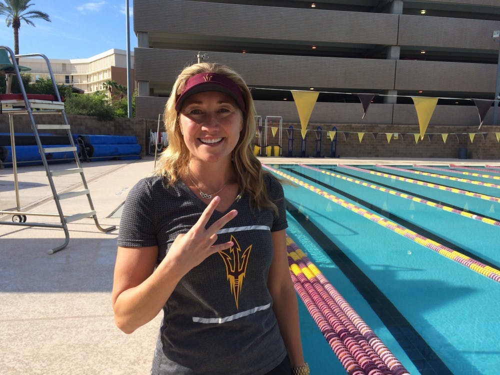 Misty Hyman poses for a photo on the pool deck of the Mona Plummer Aquatic Center in Tempe.