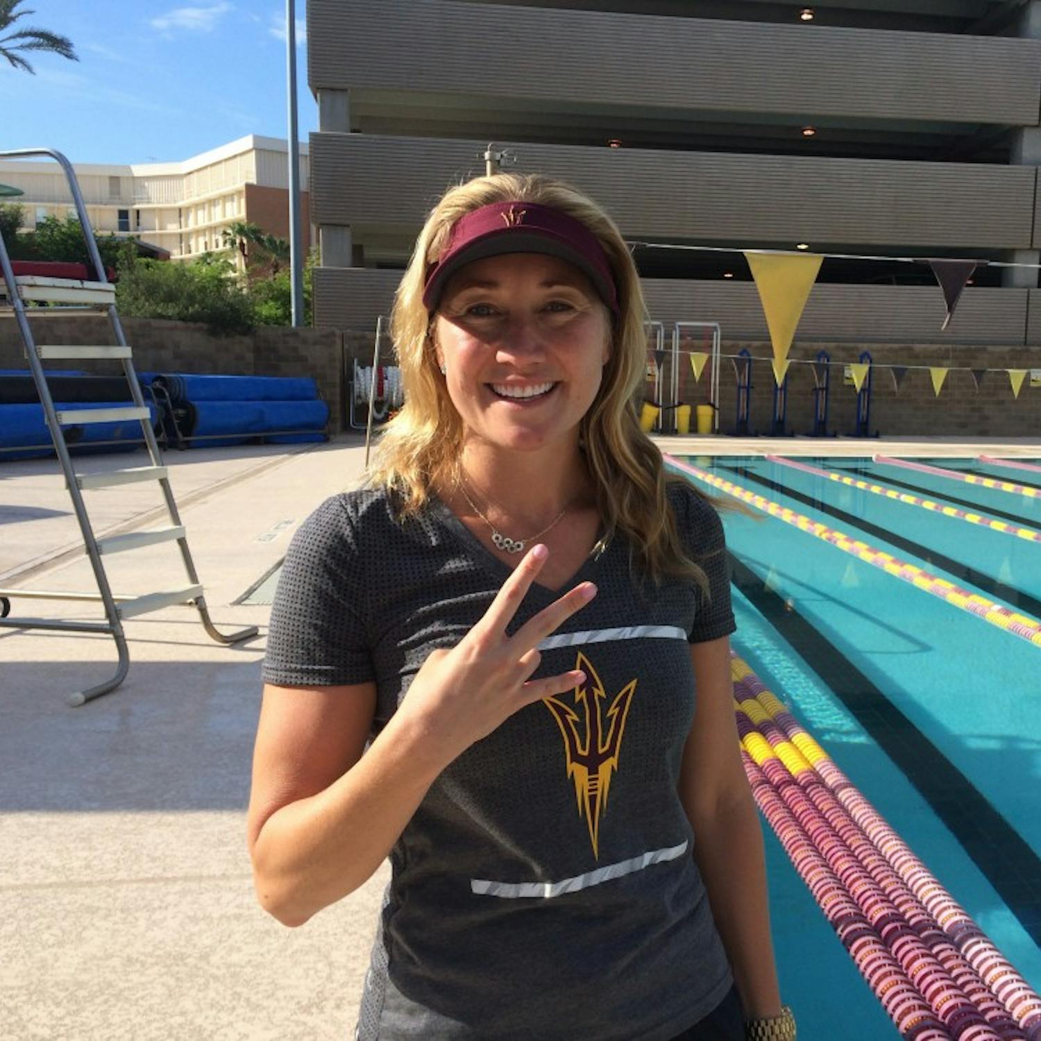 Misty Hyman poses for a photo on the pool deck of the Mona Plummer Aquatic Center in Tempe.