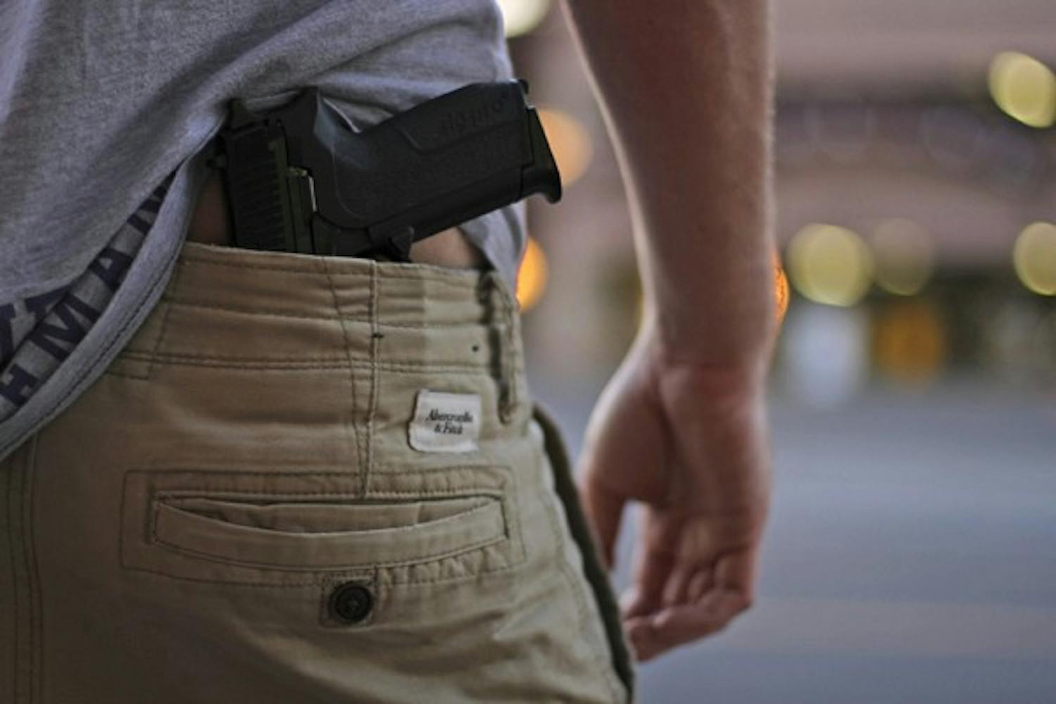 A handgun is concealed in this photo illustration.&nbsp;