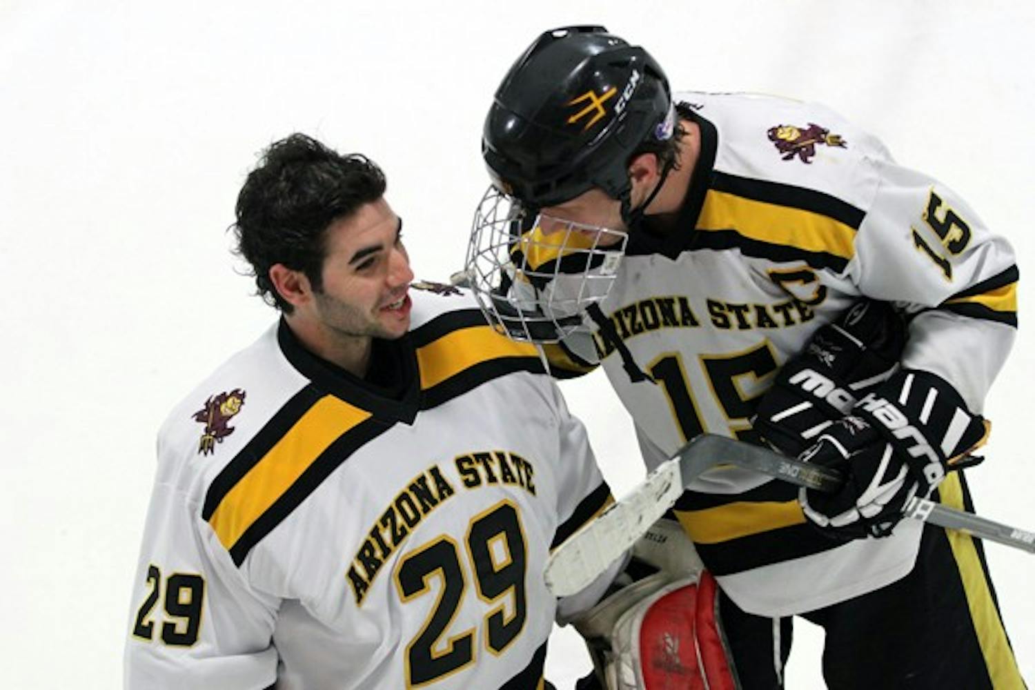 Goaltender Joe D’Elia talks to forward Colin Hekle during ASU’s win over Davenport on Jan. 18. In his first start for ASU, D’Elia recorded a win and shutout over his former team. (Photo by Lisa Bartoli)
