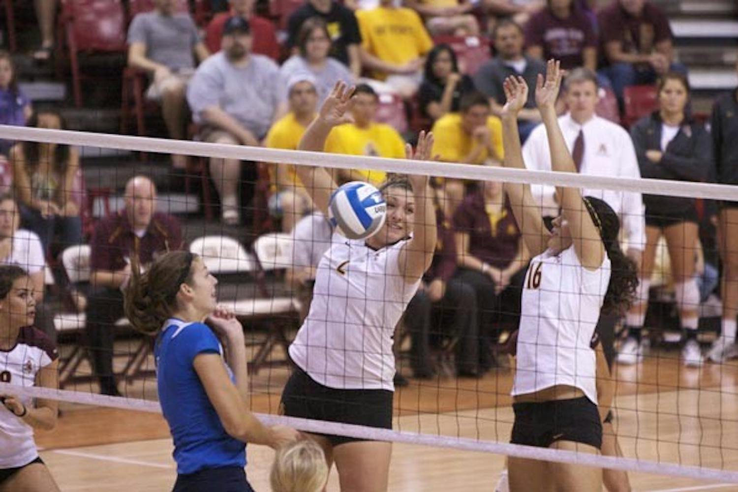 TAKE TWO: Junior middle blocker Sonja Markanovich (left) and freshman outside hitter Danica Mendivil jump for a block against UCLA on Oct. 16. After losing to UA in Tucson earlier this season, the Sun Devils get another chance when they hose their rival on Friday. (Photo by Scott Stuk)