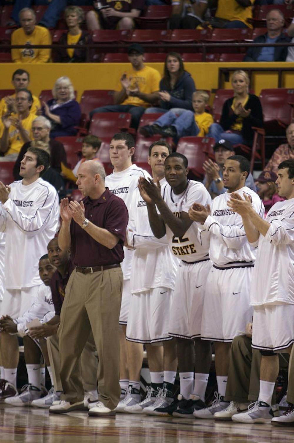 HANDS TOGETHER: Coach Herb Sendek and his players cheer on their team in one of ASU's many wins thing season. The Devil's finished their season with an overall record of 22-11. (Photo by Scott Stuk)
