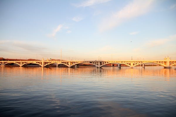 The setting sun casts a yellow glow across Tempe Town Lake early Wednesday evening. (Photo by Diana Lustig)