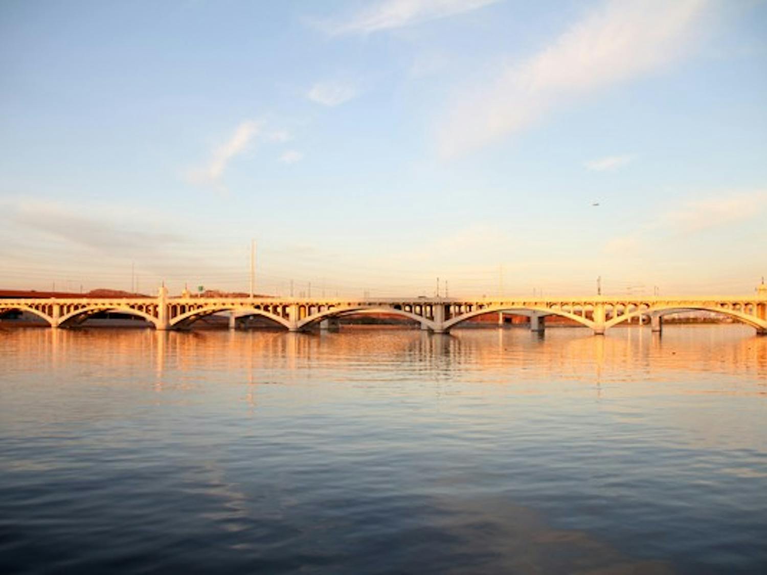 The setting sun casts a yellow glow across Tempe Town Lake early Wednesday evening. (Photo by Diana Lustig)