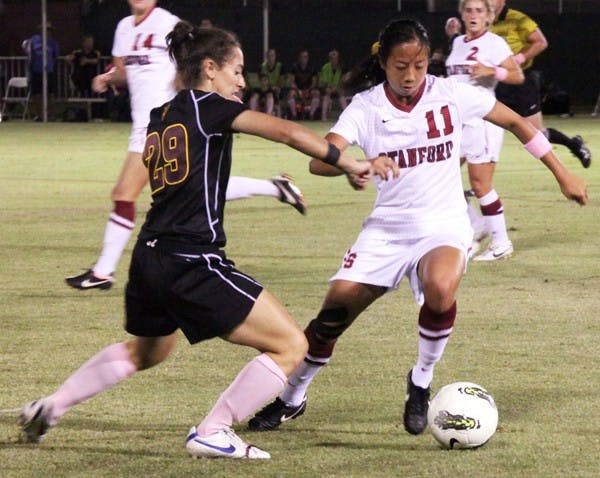 OVERWHELMED: ASU redshirt sophomore Nicki Stone tries to knock the ball away from junior defender Rachel Quon during Stanford’s 3-1 victory on Friday. Stanford used a strong possession game to frustrate the Sun Devils and cruise to the win. (Photo by  Rosie Gochnour)