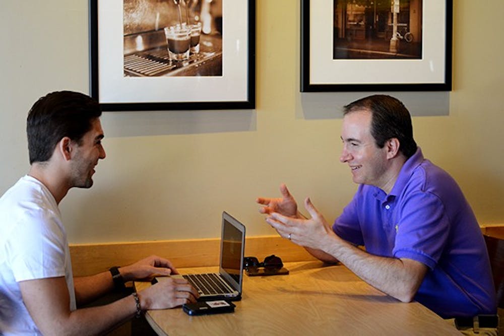 Louie Cesario, left, and CEO David Cogan discuss Eliances at a Starbucks in Tempe on Monday, Oct. 27, 2014. They regularly meet at ASU Skysong to discuss new ideas about the company. (Photo by Jonathan Williams)