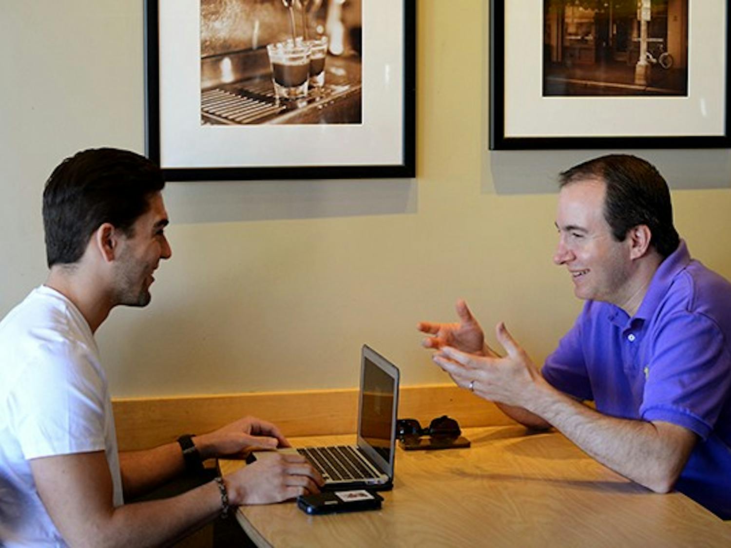 Louie Cesario, left, and CEO David Cogan discuss Eliances at a Starbucks in Tempe on Monday, Oct. 27, 2014. They regularly meet at ASU Skysong to discuss new ideas about the company. (Photo by Jonathan Williams)