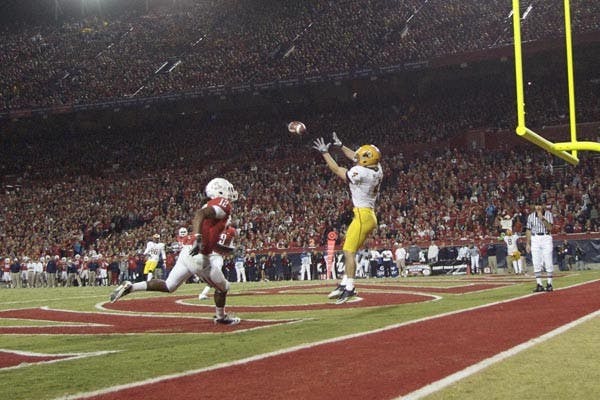 STRANGE SIGHTS: Redshirt junior wide receiver Aaron Pflugrad attempts to catch a pass during ASU's win over UA last Thursday. The game saw plenty of strange plays and seemingly endless irony, as the Sun Devils came out on the positive side of  an usual ending. (Photo by Scott Stuk)