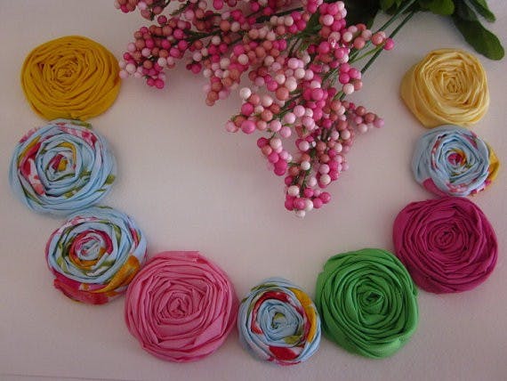 Beautiful fabric rosettes. Photo taken from DFinnitive Creations' Etsy store.