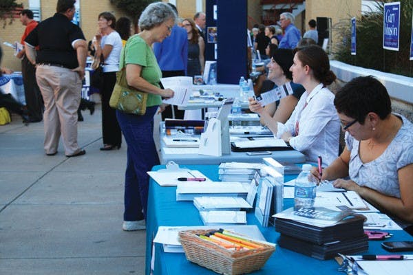 People gathered at tables set up by organizations, politicians and programs at the Arizona Town Hall forum at Central High School in downtown Phoenix Thursday evening. (Photo by Jessie Wardarski)