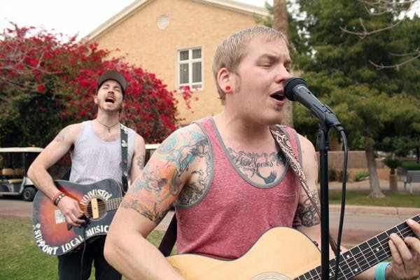 Alex Fuhr, right, and Ty Warden, left, of the band Last Chance Casanova rock out on Hayden Lawn Monday afternoon. (Photo by Jenn Allen)