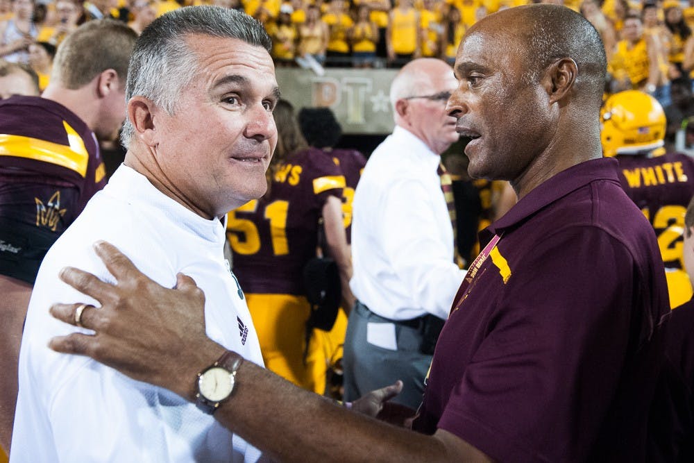 Head coach Todd Graham (left) is congratulated by athletic director Ray Anderson after the Sun Devils defeated Cal Poly on Saturday, Sept. 12, 2015, at Sun Devil Stadium in Tempe.