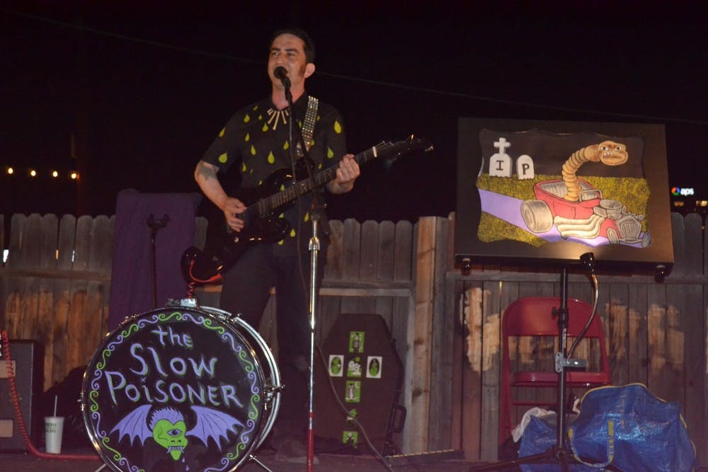 The Slow Poisoner, Andrew Goldfarb, performs onstage at Lawn Gnome Publishing on June 24, 2016. Lawn Gnome is a bookstore and publishing company that hosts a variety of arts-related events in central Phoenix.&nbsp;
