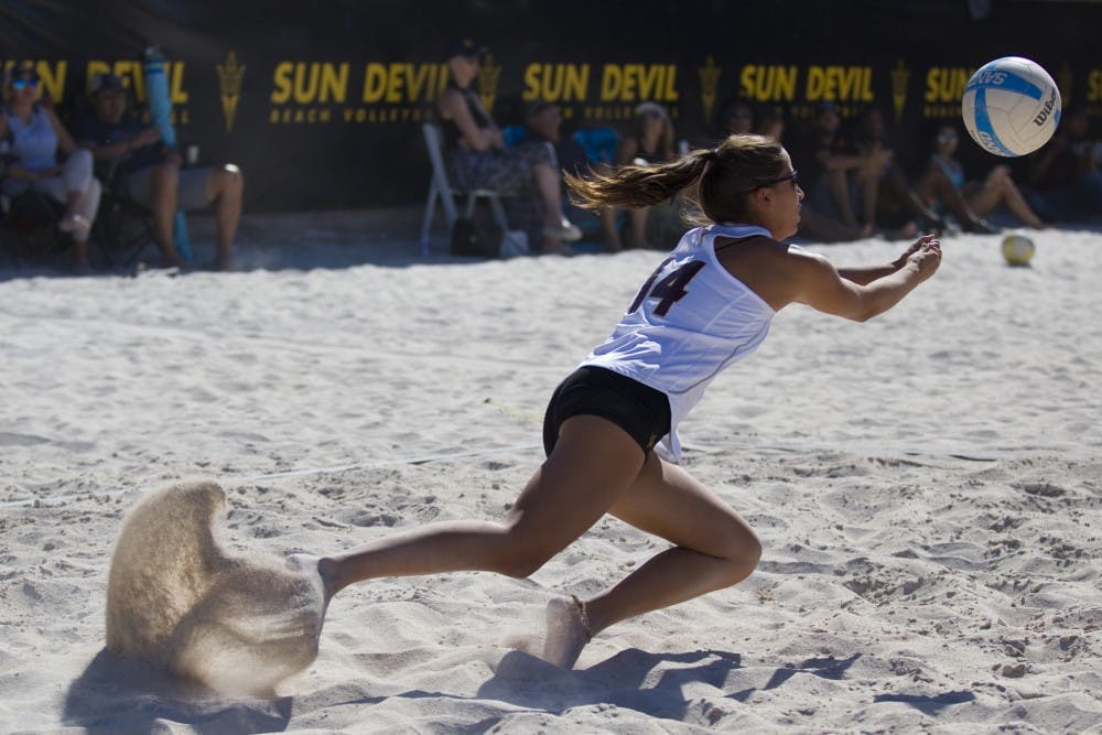 ASU junior Mia Rivera (14) dives after a ball during a beach volleyball match against the University of California Golden Bears at PERA Club in Tempe, Arizona on Friday, April 21, 2017.