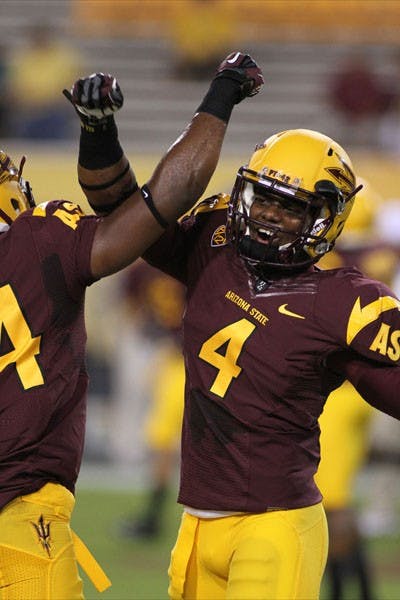 Junior safety Alden Darby (right) celebrates with a teammate during the Sun Devils’ 63-6 win over NAU on Aug. 30. (Photo by Sam Rosenbaum)
