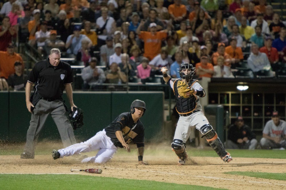 Junior RJ Ybarra gets tagged out at home plate after an unsuccessful suicide squeeze attempt by Sophomore Zach Cerbo  against Oregon State at Phoenix Municipal Stadium on Friday March 13, 2015. (Jacob Stanek/ The State Press)