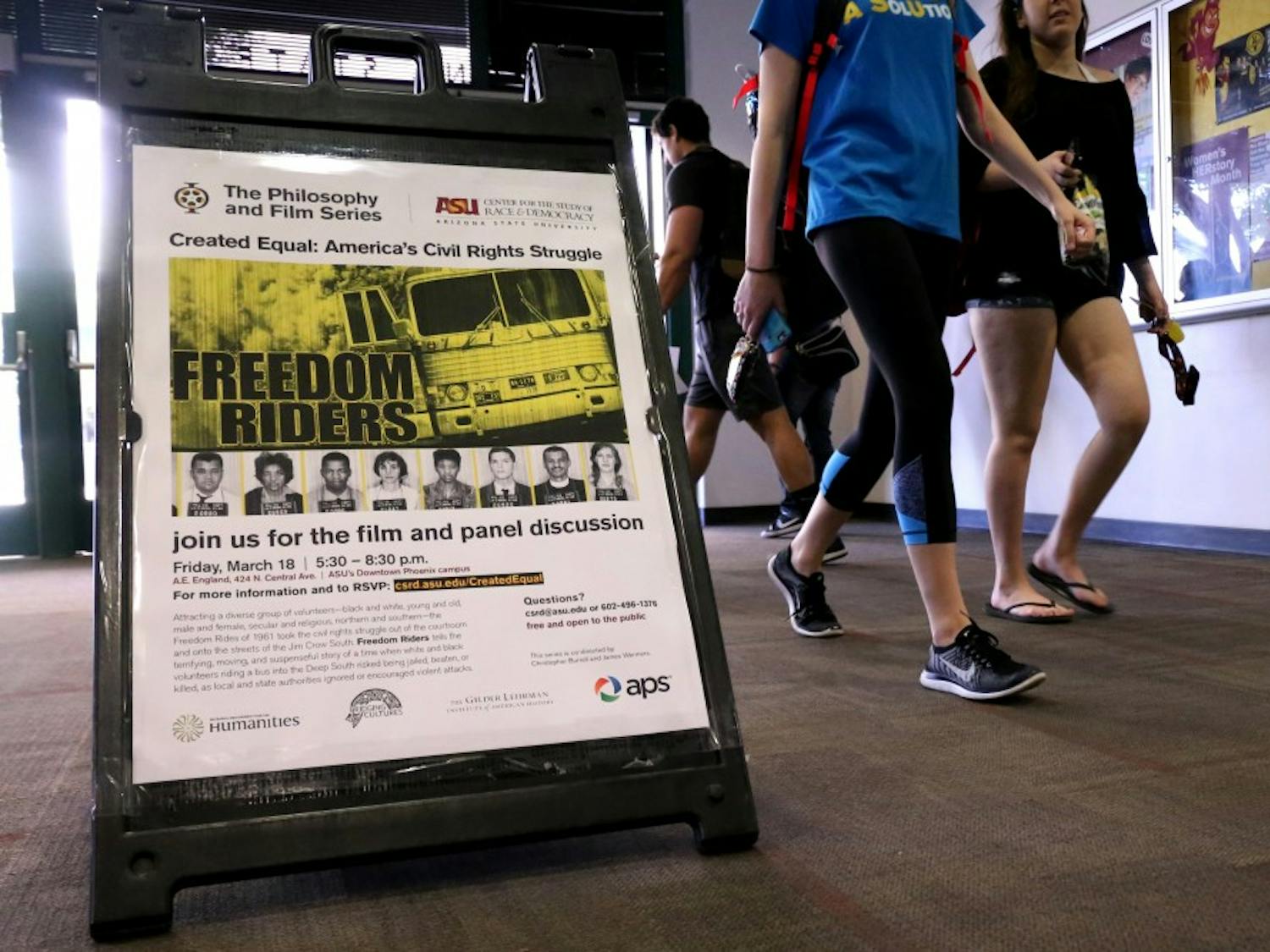 Students walk past a sign on Wednesday, March 16, 2016, in the University Center building advertising 'Freedom Riders' as the next film in the series of Created Equal: America's Civil Rights Struggle.