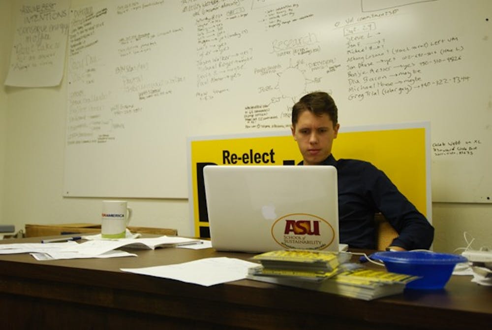Will Greene, an ASU alumnus, reviews his agenda for the day. Greene is the campaign manager for Democrat Paul Newman, who is seeking a second term at the Arizona Corporation Commission. (Photo by Danielle Gregory)