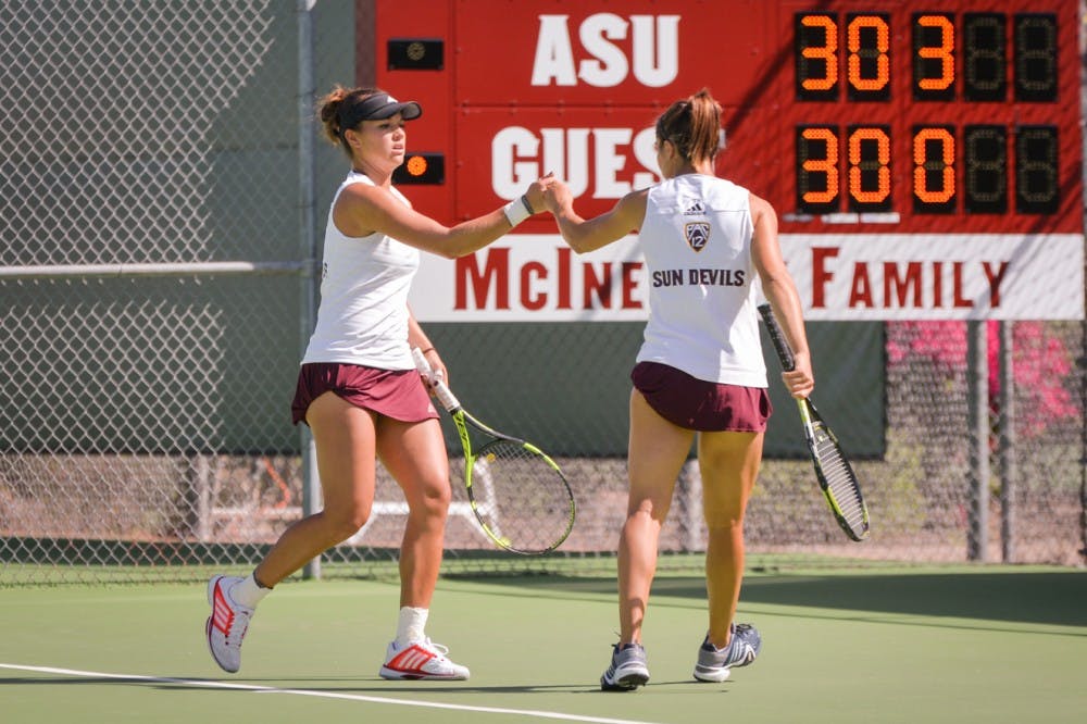 Desirae Krawczyk, left, and Stephanie Vlad, right, celebrate the point with a fist bump during the match-up against the California Bears on Friday, March 4, 2016, at the Whiteman Tennis Center in Tempe, Arizona.