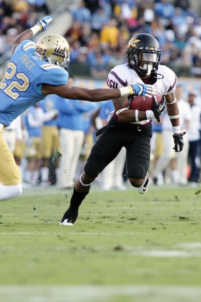 SPEED KILLS: ASU junior wide receiver Jamal Miles (ball) steers around a tackle by UCLA junior cornerback Sheldon Price during the Bruins’ 29-28 win over the Sun Devils. Miles and the Sun Devils’ quick-tempo offense should be keys to an ASU victory over Washington State on Saturday. (Photo by Beth Easterbrook)