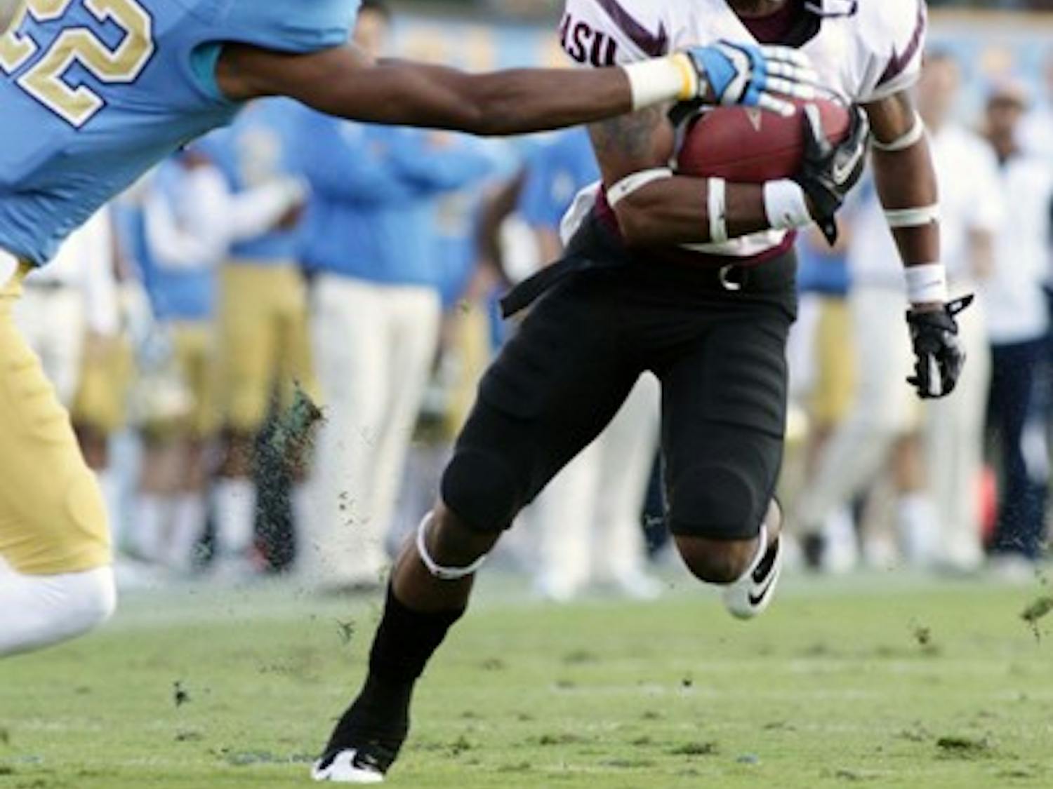 SPEED KILLS: ASU junior wide receiver Jamal Miles (ball) steers around a tackle by UCLA junior cornerback Sheldon Price during the Bruins’ 29-28 win over the Sun Devils. Miles and the Sun Devils’ quick-tempo offense should be keys to an ASU victory over Washington State on Saturday. (Photo by Beth Easterbrook)