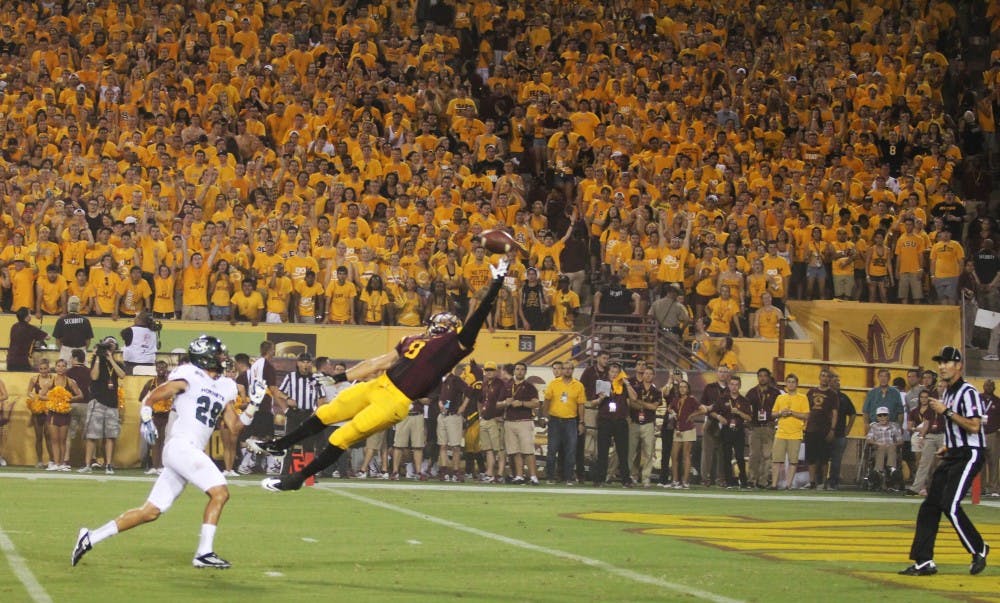 Sophomore running back D.J. Foster dives for a pass in Tempe against Sacramento state (0-1). The Sun Devils won in a 55-0 blowout on Thursday. (Photo by Diana Lustig)