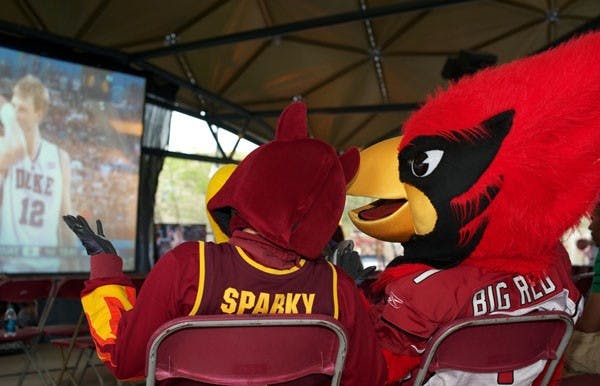 ENJOYING THE GAME: Sparky and the Sun's own Big Red trade game predictions during the 2010 NCAA Finals game between Duke and Butler. The game was broadcast on the jumbo screen in the Vista del Sol Dome, and food, drinks, and activities were provided by the PAB student body. (Photo by Michael Arellano)