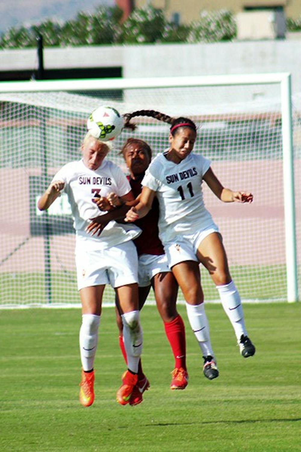 Junior defenders McKenzie Berryhill and Rachel Ometer attempt a header in a home game against Stanford on Oct. 26, 2014. Stanford won the game 2-0. (Photo by Sawyer Hardebeck)