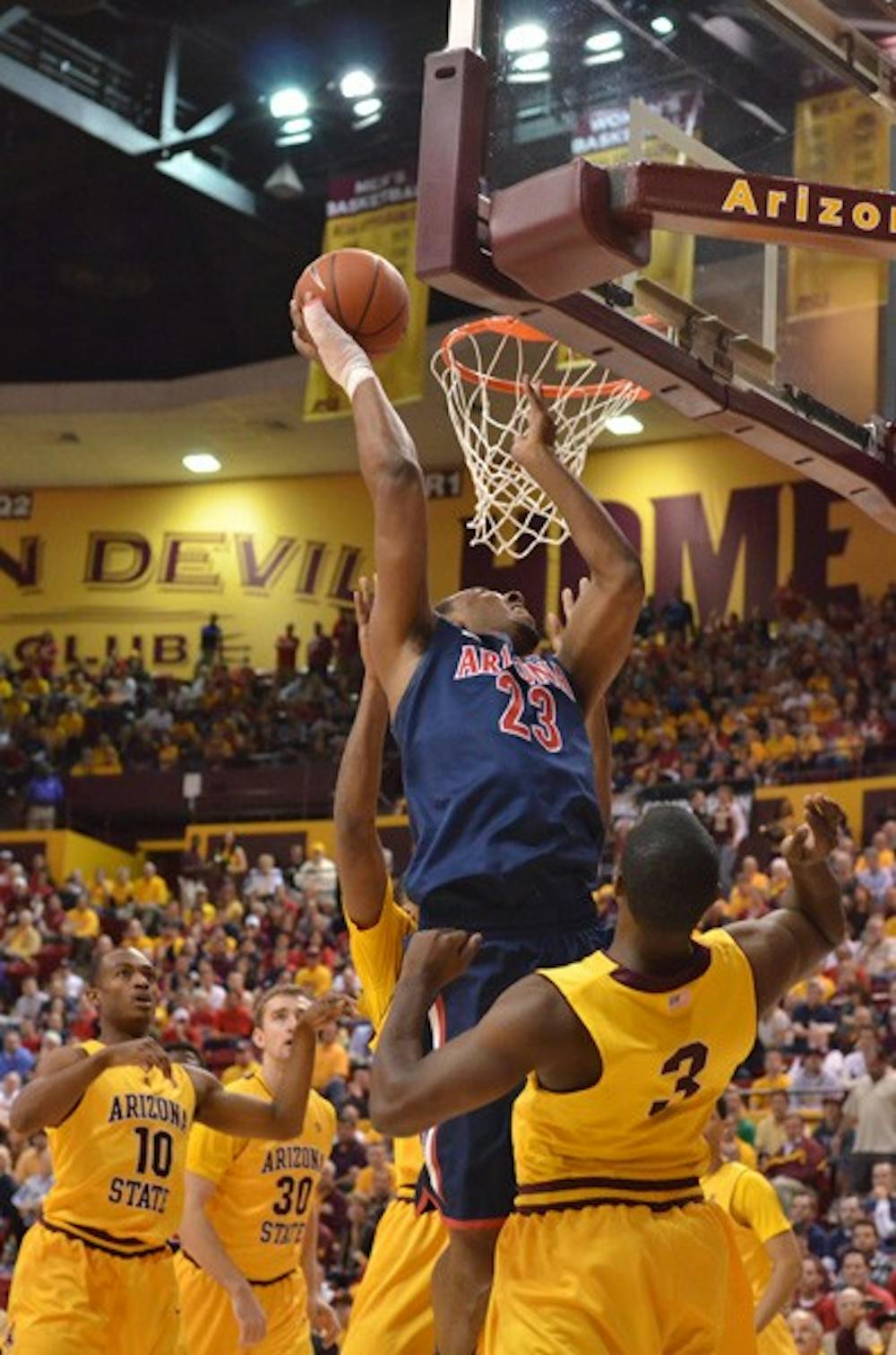 No success: UA sophomore forward Derrick Williams goes up for a layup over the top of ASU senior guard Ty Abbott during the Wildcats’ 67-52 victory over the Sun Devils in Tempe on Sunday night. It was ASU’s 10th straight Pac-10 loss (Photo by Aaron Lavinsky)