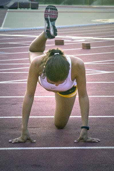GETTING A LEG UP: Senior cross country runner Anna Sperry stretches before a recent practice. Sperry has emerged as the leader of the women's squad, which is crucial as the Oct. 30 Pac-10 Championships approach. (Photo by Annie Wechter)