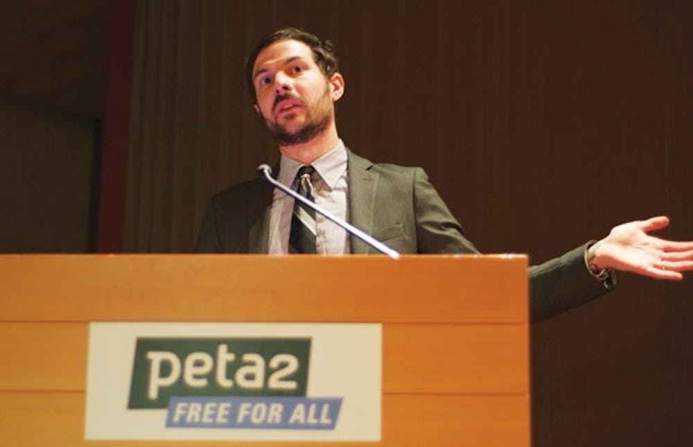 EMPTY DEBATE: Justin Goodman, Research Associate Supervisor for the Laboratory Investigation Department at PETA, gives a presentation on ways for ASU to stop its use of animals in lab experiments. He stood next to an empty podium; PETA had continually extended invitations to ASU officials to discuss the issue with them at the event, but ASU declined. (Photo by Molly J. Smith)