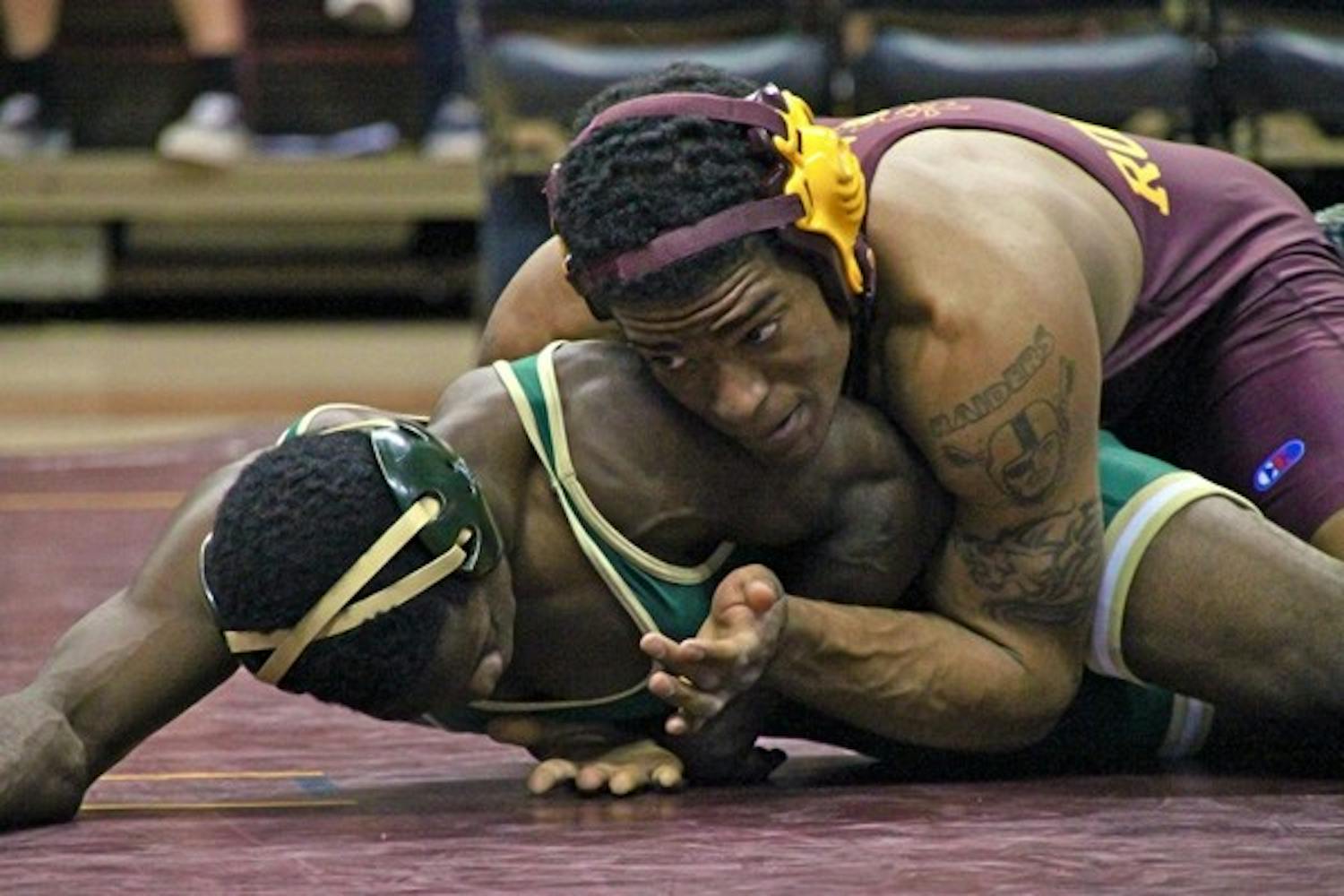 Finishing Strong: ASU senior Anthony Robles rides Cal Poly’s Britain Longmire during Robles’ 16-0 technical fall victory on Jan 30. The Sun Devils head up to face No. 21 Oregon State and Stanford this weekend to close out the regular season. (Photo by Rosie Gochnour)