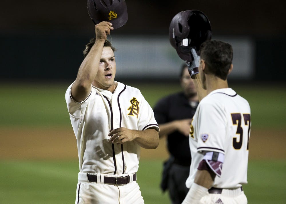 ASU baseball's David Greer, left, celebrates with teammate Colby Woodmansee after scoring a home run during a game against the University of Arizona Wildcats at Phoenix Municipal Stadium in Phoenix, Arizona, on Tuesday, April 12, 2016. 