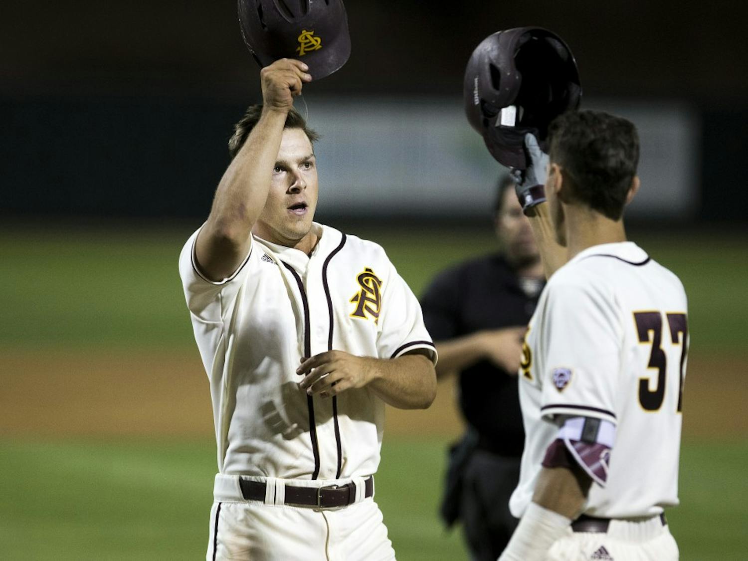 ASU baseball's David Greer, left, celebrates with teammate Colby Woodmansee after scoring a home run during a game against the University of Arizona Wildcats at Phoenix Municipal Stadium in Phoenix, Arizona, on Tuesday, April 12, 2016. 