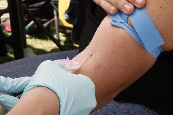 The One Glove sexual health awareness event offered free STD testing for students Wednesday afternoon on Hayden Lawn. (Photo by Cameron Tattle)